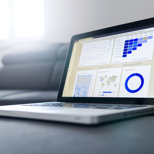 Sleek laptop showcasing data analytics and graphs on the screen in a bright room.